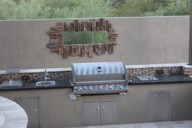 Backyard BBQ and outdoor seating area with paver hardscape