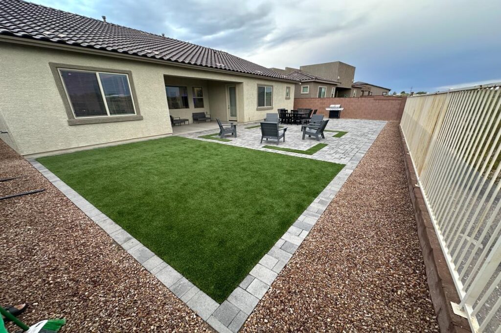 Artificial turf installation with paver border in Tucson backyard